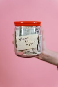 jar full of money held by a person